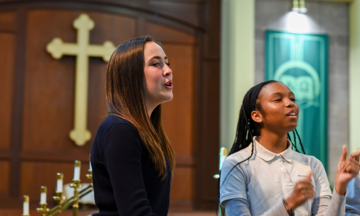 two students singing in church
